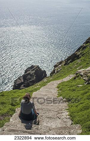 Picture - Hiker on footpath climbing up Skellig Michael; Skellig Islands, County Kerry, Ireland, UK. Fotosearch