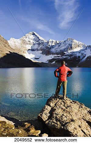 Hiker Overlooking Lake Mcarthur And Mount Biddle At Sunset, Yoho National Park, British Columbia View Large Photo Image Stock Image - Hiker Overlooking Lake Mcarthur And Mount Biddle At Sunset, Yoho National Park, British Columbia. Fotosearch
