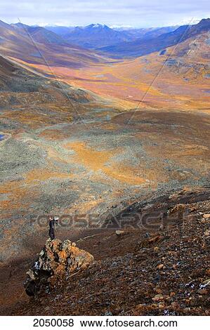 Hiker Standing On Rocky Outcropping On Mountain In Tombstone Territorial Park, Yukon View Large Photo Image Stock Photo - Hiker Standing On Rocky Outcropping On Mountain In Tombstone Territorial Park, Yukon. Fotosearch
