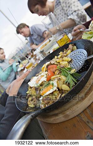 Stock Image - Hikers enjoying a mountain dinner on the terrace of the HornkÃƒâ€¦Ã‚Â¡pfl hut. KitzbÃƒâ€¦Ã‚Â¸heler Horn. Kitzbuehel. Tyrol. Austria.. Fotosearch