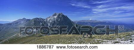Stock Photo - Hikers Going Up Ridge With Corno Grande Behind, Campo Imperatore. Fotosearch