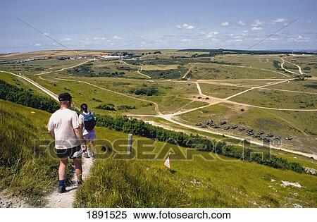 Stock Photography - Hikers On Path Through Firing Ranges, Rear View. Fotosearch