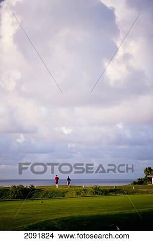 Picture - Hikers On The Coastal Makai Golf Course; Princeville, Kauai, Hawaii. Fotosearch
