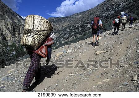 Hikers, Porter, North-West Nepal. View Large Photo Image Stock Photo - Hikers, Porter, North-West Nepal.. Fotosearch