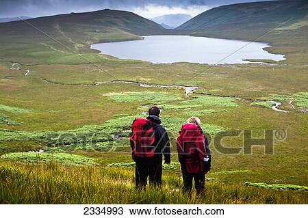 Hikers With Burnmoor Tarn; Western Lake District, Cumbria, England, Uk View Large Photo Image Stock Image - Hikers With Burnmoor Tarn; Western Lake District, Cumbria, England, Uk. Fotosearch