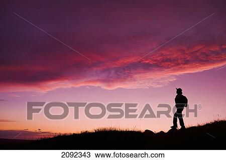 Stock Image - Hiking In West Block Of Grasslands National Park At Sunset; Saskatchewan Canada. Fotosearch