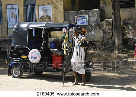 Stock Photography - Hindu Man In Traditional Clothes Outside Rickshaw In Belur, Karnataka, India. Fotosearch