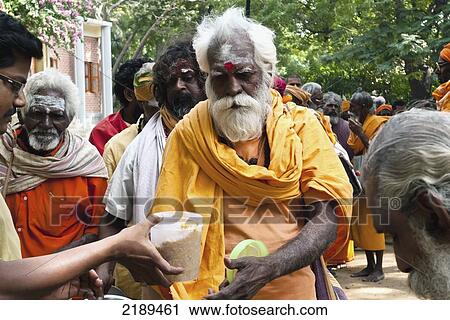 Stock Image - Hindu Pilgrims Having A Free Lunch, As Part Of Seva, At The Ramana Maharishi Ashram In Tiruvannamali, Tamil Nadu, India. Fotosearch