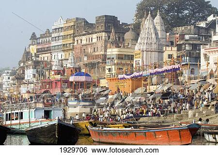 Hindu pilgrims immersed in the waters at the bathing ghats. Photograph taken while being rowed on the sacred but polluted River Ganges. The culture of Varanasi is closely associated with the River Ganges and the river's religious importance. It is the re View Large Photo Image Stock Photograph - Hindu pilgrims immersed in the waters at the bathing ghats. Photograph taken while being rowed on the sacred but polluted River Ganges. The culture of Varanasi is closely associated with the River Ganges and the river's religious importance. It is the re. Fotosearch