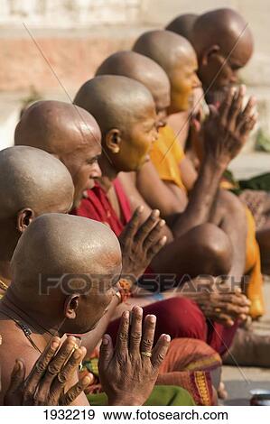 Hindus Having Had Their Heads Shaved, Due To An Auspicious Occasion, Praying During A Religious Service, At A Bathing Ghat On The Banks Of The River Ganges. Uttar Pradesh State, India, Asia. View Large Photo Image Stock Photo - Hindus Having Had Their Heads Shaved, Due To An Auspicious Occasion, Praying During A Religious Service, At A Bathing Ghat On The Banks Of The River Ganges. Uttar Pradesh State, India, Asia.. Fotosearch