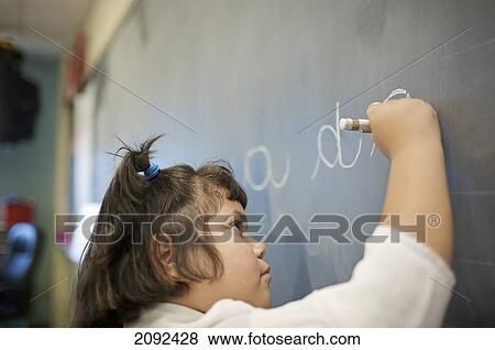 Hispanic Girl Writing On Blackboard In An Esl School; Guelph Ontario Canada View Large Photo Image Stock Photo - Hispanic Girl Writing On Blackboard In An Esl School; Guelph Ontario Canada. Fotosearch