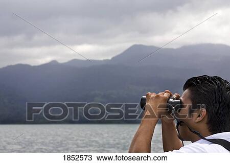 Hispanic Man Looking Through Binoculars, Costa Rica View Large Photo Image Stock Image - Hispanic Man Looking Through Binoculars, Costa Rica. Fotosearch