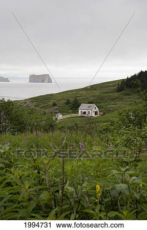 Stock Image - Historic House On Bonaventure Island With Rocher-Perc In The Distance; Perce Quebec Canada. Fotosearch