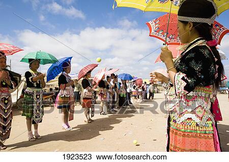 Stock Image - Hmong Girls In Traditional Costume Throwing Tennis Balls At A Courting Ceremony At The New Year Festival, Phonsavan, Laos. Fotosearch