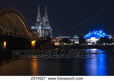 Hohenzollern Bridge and Cologne Cathedral at nighttime; Cologne, Germany View Large Photo Image Stock Photo - Hohenzollern Bridge and Cologne Cathedral at nighttime; Cologne, Germany. Fotosearch
