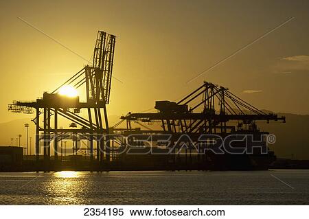 Stock Photography - Hoisting cranes in Honolulu harbour; Honolulu, Oahu, Hawaii, United States of America. Fotosearch