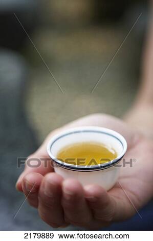 Stock Photo - Holding teacup Maokong tea plantation Taiwan. Fotosearch