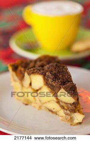 Picture - Holland, Apple cake and cappuccino with biscuit in 'Tart of my Aunt' cafe; Amsterdam. Fotosearch