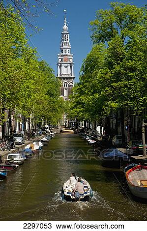 Holland, Couple in boat going along canal with spire of Zuiderkerk church in background; Amsterdam View Large Photo Image Stock Image - Holland, Couple in boat going along canal with spire of Zuiderkerk church in background; Amsterdam. Fotosearch