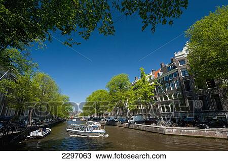 Holland, Cruise boats going up and down canal; Amsterdam View Large Photo Image Stock Image - Holland, Cruise boats going up and down canal; Amsterdam. Fotosearch
