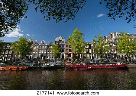 Holland, Dutch barges on canal and gabled houses; Amsterdam View Large Photo Image Stock Image - Holland, Dutch barges on canal and gabled houses; Amsterdam. Fotosearch