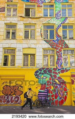 Holland, Man walking past large mural of snake painted on front of building; Amsterdam View Large Photo Image Stock Image - Holland, Man walking past large mural of snake painted on front of building; Amsterdam. Fotosearch