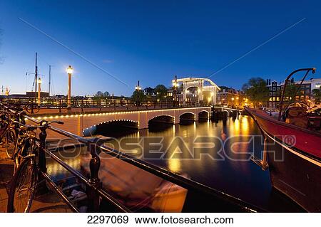 Holland, View of Magere Brug or Skinny Bridge at dusk; Amsterdam View Large Photo Image Stock Photo - Holland, View of Magere Brug or Skinny Bridge at dusk; Amsterdam. Fotosearch