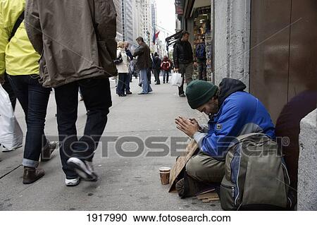 Stock Image - Homeless Man Prays For Help. Fotosearch