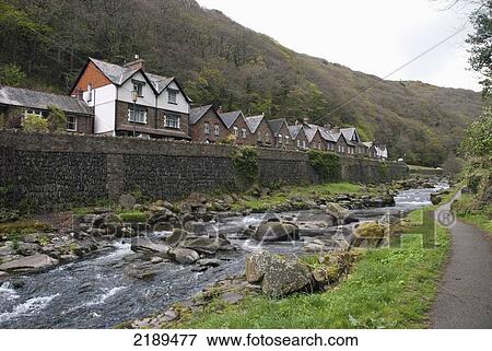 Stock Photo - Homes Along The Lynmouth River With Walking Path On The Right, Exmoor, United Kingdom. Fotosearch