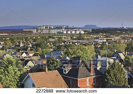 Stock Photo - Homes and industrial buildings; thunder bay ontario canada. Fotosearch