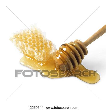 Picture - Honey from a honeycomb on a white background. Fotosearch