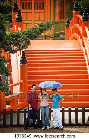 Stock Photo - Hong Kong, Diamond Hill Nk, Chi Lin Nunnery. Tourists Pose In Front Of Tang Style Buddhist Nunnery. Editorial Use Only.. Fotosearch