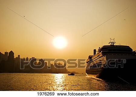 Stock Photo - Hong Kong, Tsim Sha Tsui, K The Sunsets Over Victoria Harbor.. Fotosearch
