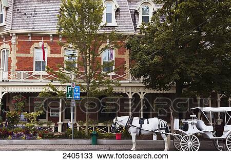 Stock Image - Horse and carriage in front of Prince of Wales Hotel; Niagara-on-the-Lake, Ontario, Canada. Fotosearch