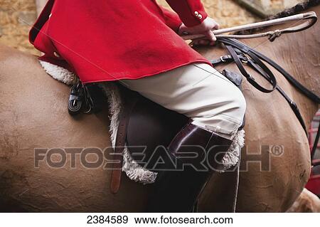 Stock Photo - Horse rider on the Traditional Boxing Day Hunt in the centre of Castle Cary; Somerset, England. Fotosearch