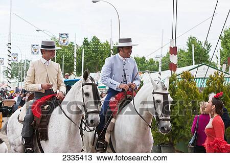 Horse Riding In Traditional Seville Clothing At April Fearia Festival; Seville, Andalucia, Spain, Europe View Large Photo Image Stock Image - Horse Riding In Traditional Seville Clothing At April Fearia Festival; Seville, Andalucia, Spain, Europe. Fotosearch