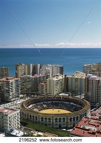 Stock Image - Horserider And Bull In Bullring Beside Blocks Of Flats In Malaga, Andalucia, Spain.. Fotosearch