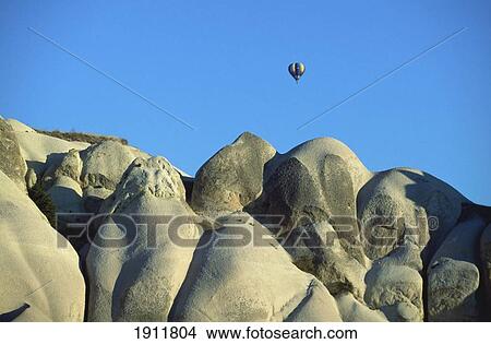 Hot Air Balloon Over Landscape In Cappadocia, Turkey View Large Photo Image Picture - Hot Air Balloon Over Landscape In Cappadocia, Turkey. Fotosearch