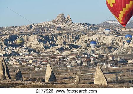 Stock Photograph - Hot Air Balloons In Flight Above The City; Goreme Nevsehir Turkey. Fotosearch