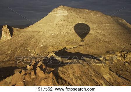 Stock Image - Hot Air Balloons Shadow Over Mountains. Fotosearch
