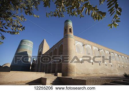 Stock Photograph - Hotel Khiva (formerly Mohammed Amin Khan Madrassah), Ichan Kala Old City, Kizilkum desert; Khiva, Khwarezm region, Uzbekistan. Fotosearch