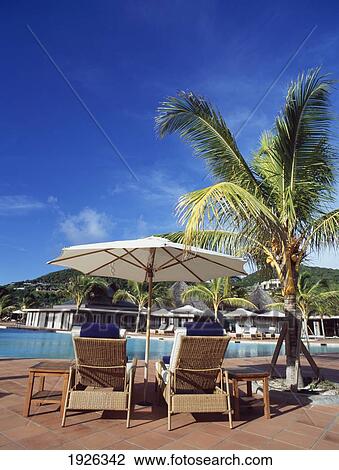 Stock Image - Hotel Swimming Pool With Sunlounger. Fotosearch