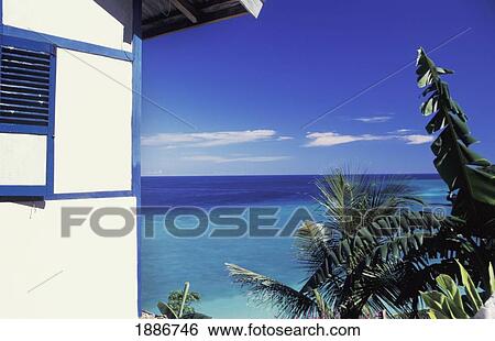 Stock Photograph - House By Clear Blue Waters. Fotosearch