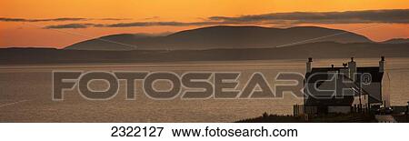 Stock Photo - House in bay at sunset; Dumfries and Galloway, Scotland, UK. Fotosearch