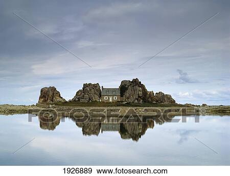 Stock Photo - House In Between Rocks Reflected. Fotosearch