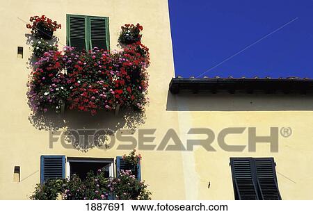 Stock Image - House With Flowers On Balcony, Close Up. Fotosearch