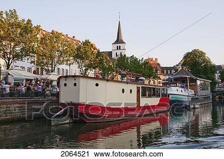 Stock Image - Houseboat In The Ill River Along The Fishermen Wharf, Strasbourg, France. Fotosearch
