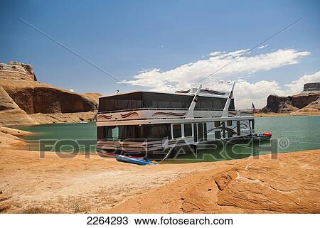 Houseboat moored with kayaks along lake powell shore; page arizona usa View Large Photo Image Stock Image - Houseboat moored with kayaks along lake powell shore; page arizona usa. Fotosearch