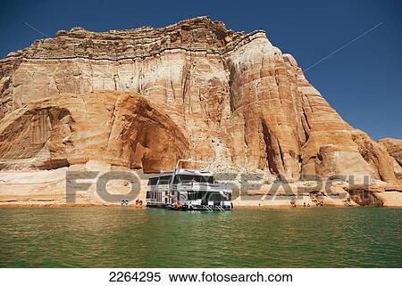 Stock Photography - Houseboat moored with kayaks along lake powell shore; page arizona usa. Fotosearch