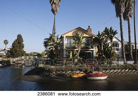 Stock Image - Houses along a river; California, United States of America. Fotosearch